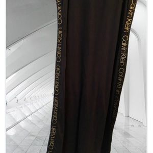 Black Calvin Klein long dress with gold C/K letters down both sides of dress..